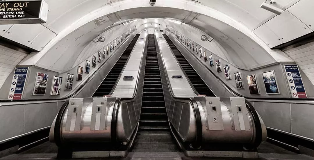 escalators heading up out of london tube station