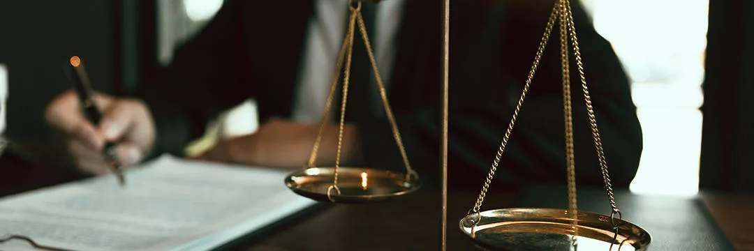 filling out forms in front of a set of scales