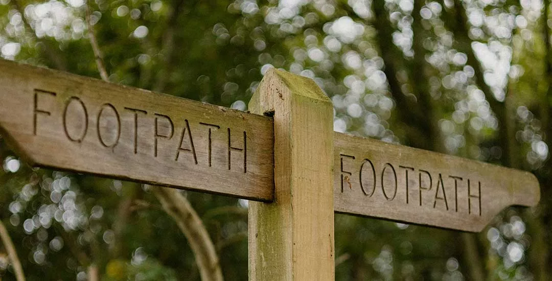 wooden footpath sign with arrow to right and left