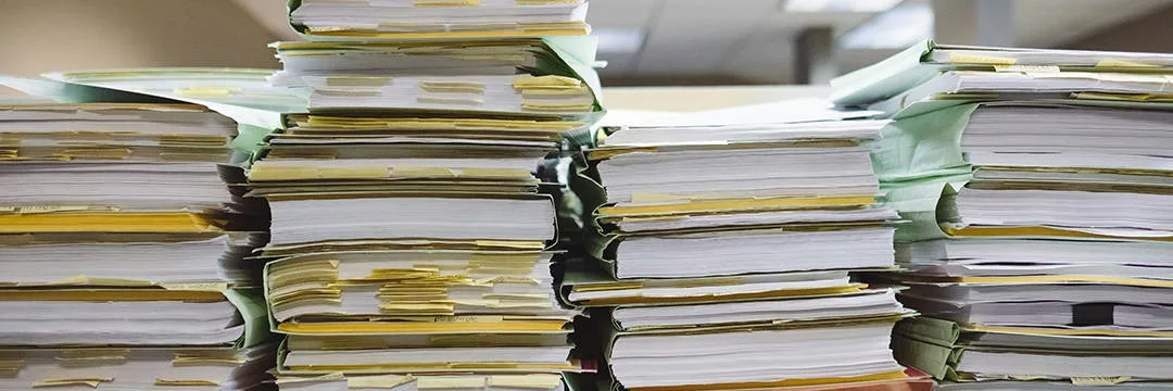 stack of company financial records and tax documentation for Contractor accountant review