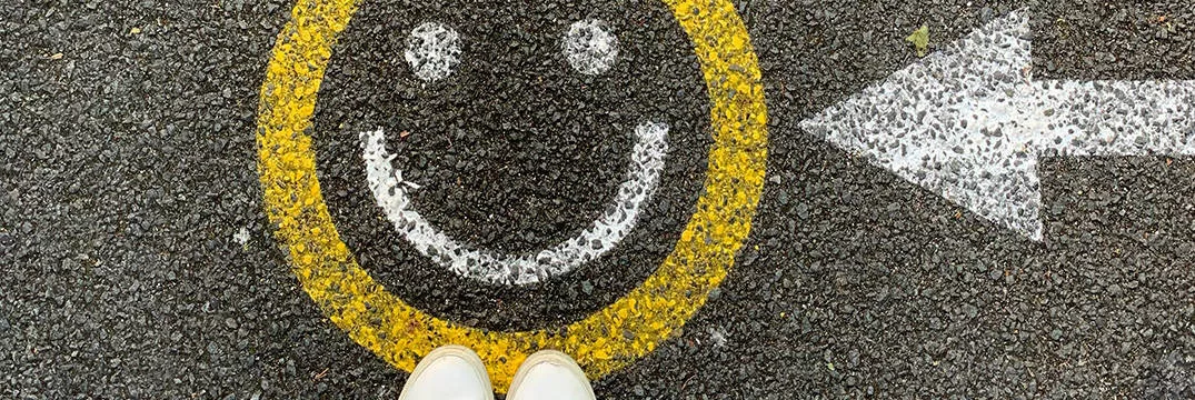 arrow on road pointing to happy face, Financial planning for future savings and tax-efficient investments leads to a happy place