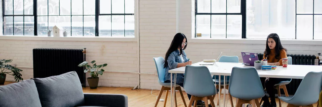People at a table inside an office studying the income tax rates in the UK