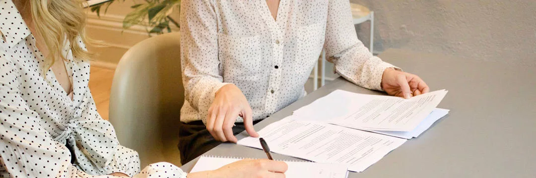 A woman looking at her dividend payment statement, showing the amount of dividend income she has received before reading our Paying Tax on Dividends article