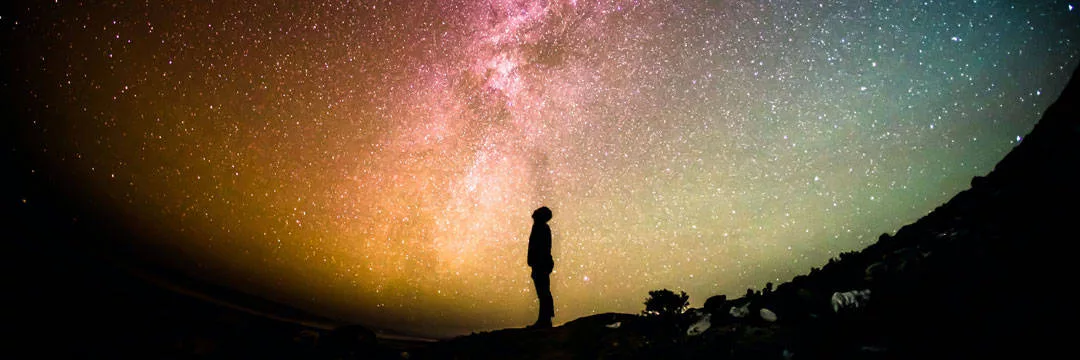 Person looking at the sky showing a global perspective on multi-currency accounting transactions