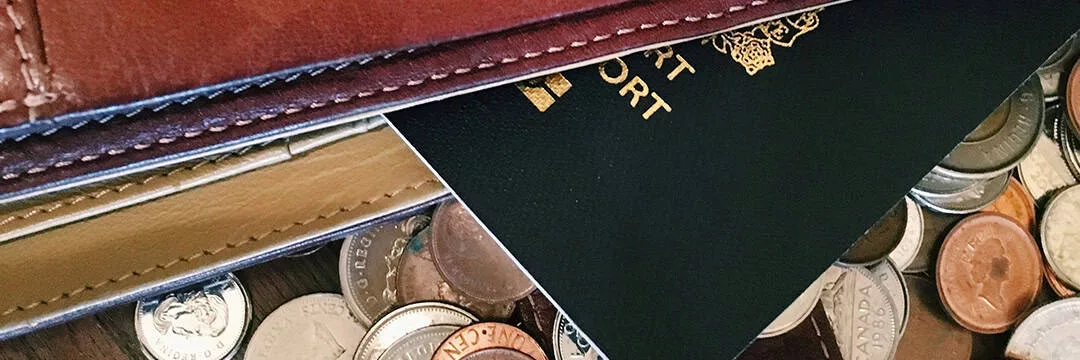 image of passport and different currency coins  to represent various types of income and their taxation between the UK and Australia.