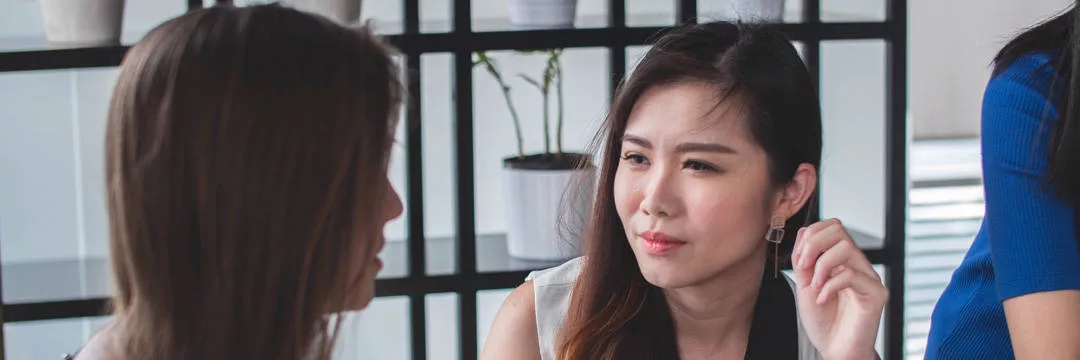 Two business owners discussing the tax benefits of taking a small salary and dividends for their personal income planning