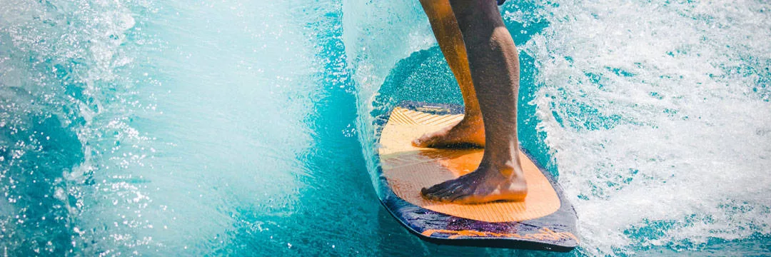 Surfing on a blue wave on a surfboard purchased with help from the tax savings of the personal allowance.