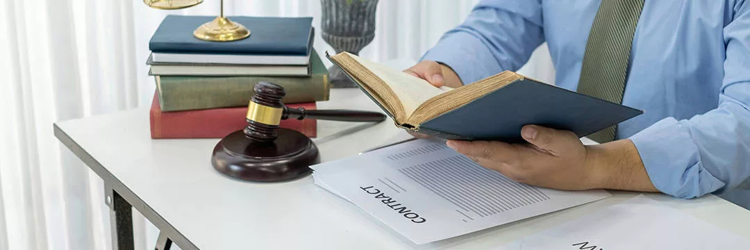 person reading legal documents to better understand legal considerations for self employed and employed individuals.