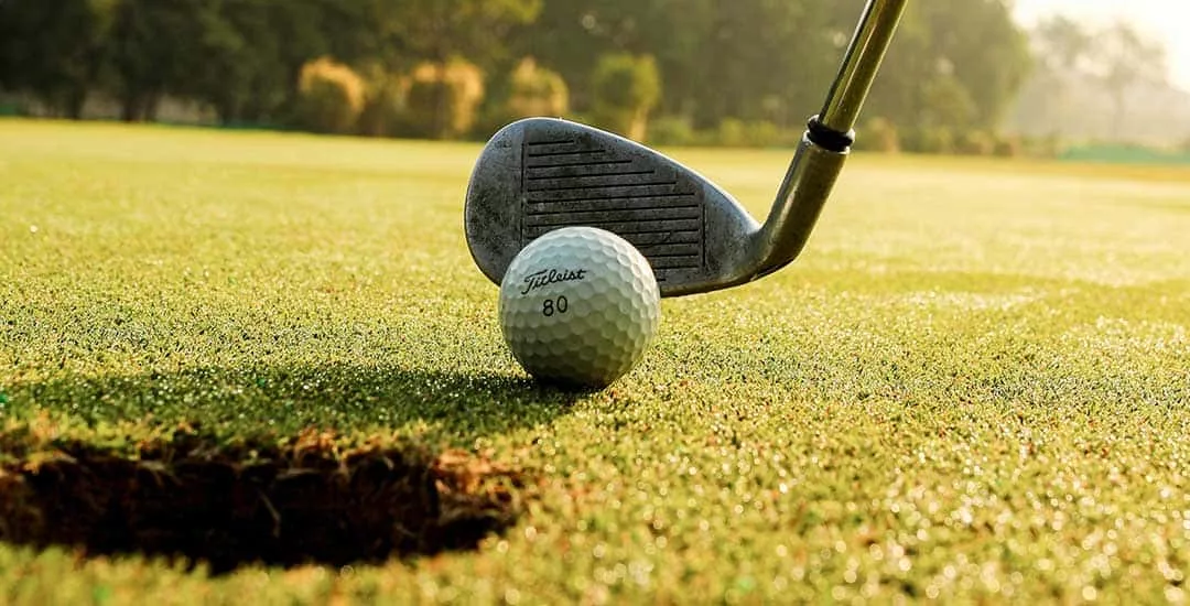 close up of someone putting on a golf course