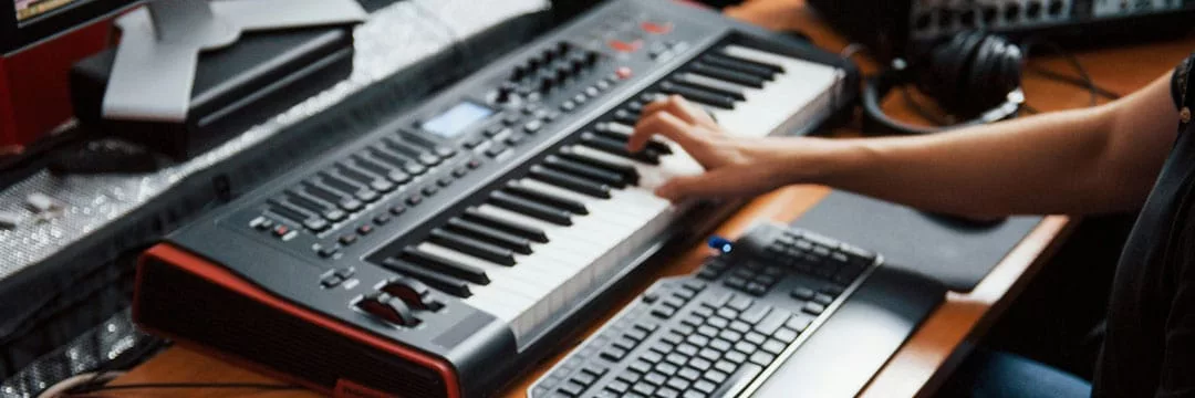 Person with sound equipment composing music using assets that have been fully expenses through their business.