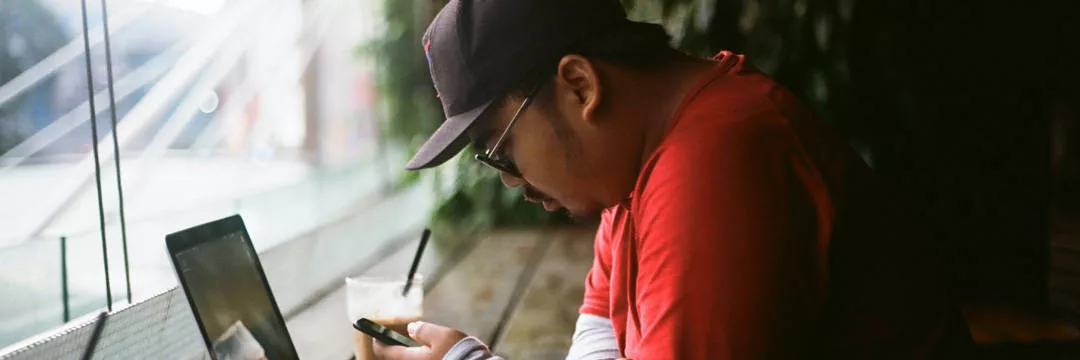 An employee in a cafe checking what their tax code means.