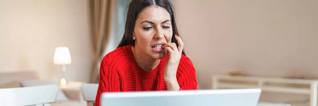 image of a woman looking at a computer screen looking unsure about how to answer the questions on the HMRC website