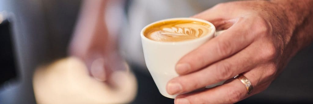 A delicious flat white coffee served helps cross border tax issues feel much easier to handle