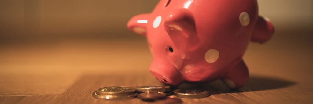 Toy pig with coins depicting open banking and childs play to set-up a bank feed