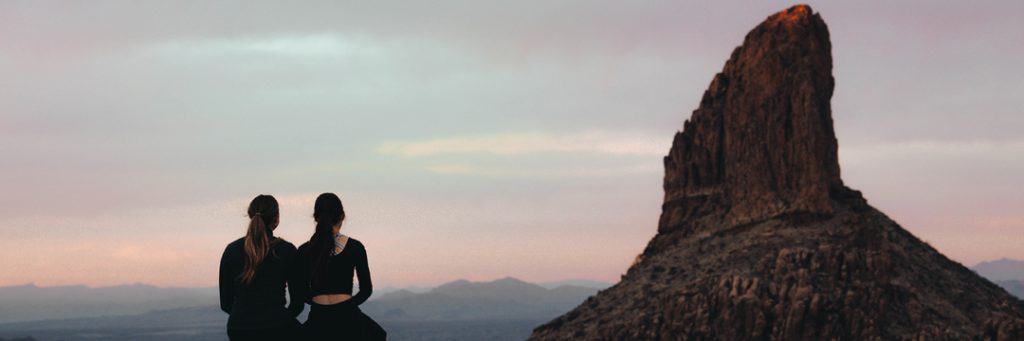 Two people staring at a mountain in the distance having just filed their personal tax returns online before 31 January.