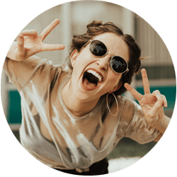 young woman wearing glasses and doing peace sign after signing up for the No Worries contractor accountant services