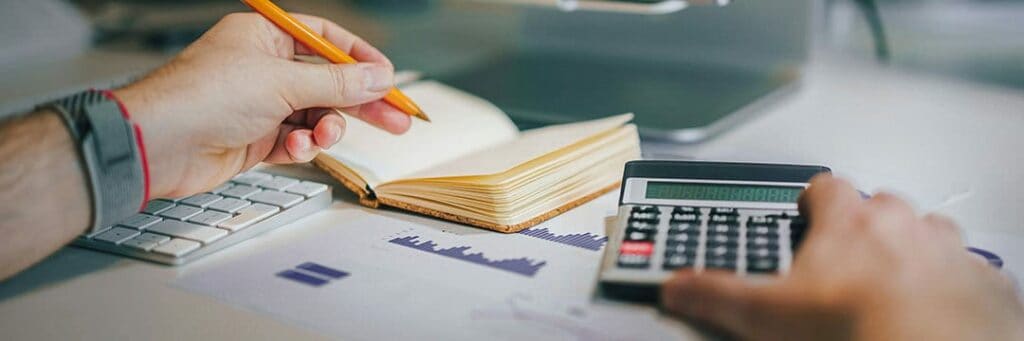 filling out tax forms and money representing paying tax on rental income