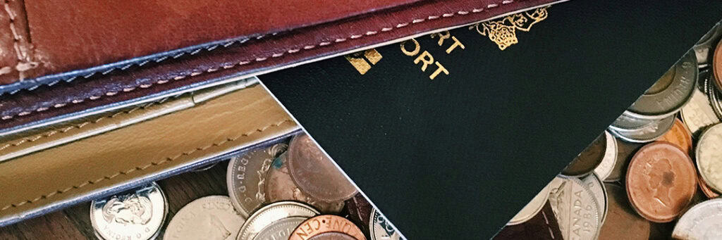 image of passport and different currency coins to represent various types of income and their taxation between the UK and Australia.