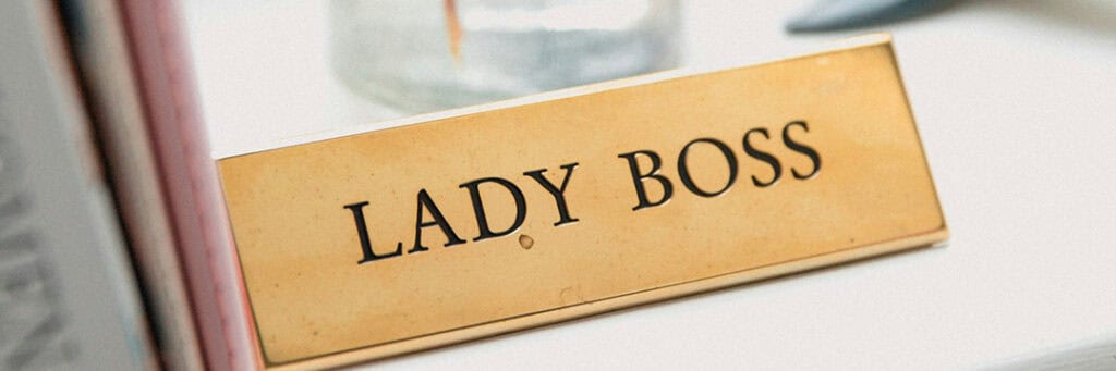 image of desk name plate that says lady boss representing benefits of working for yourself.