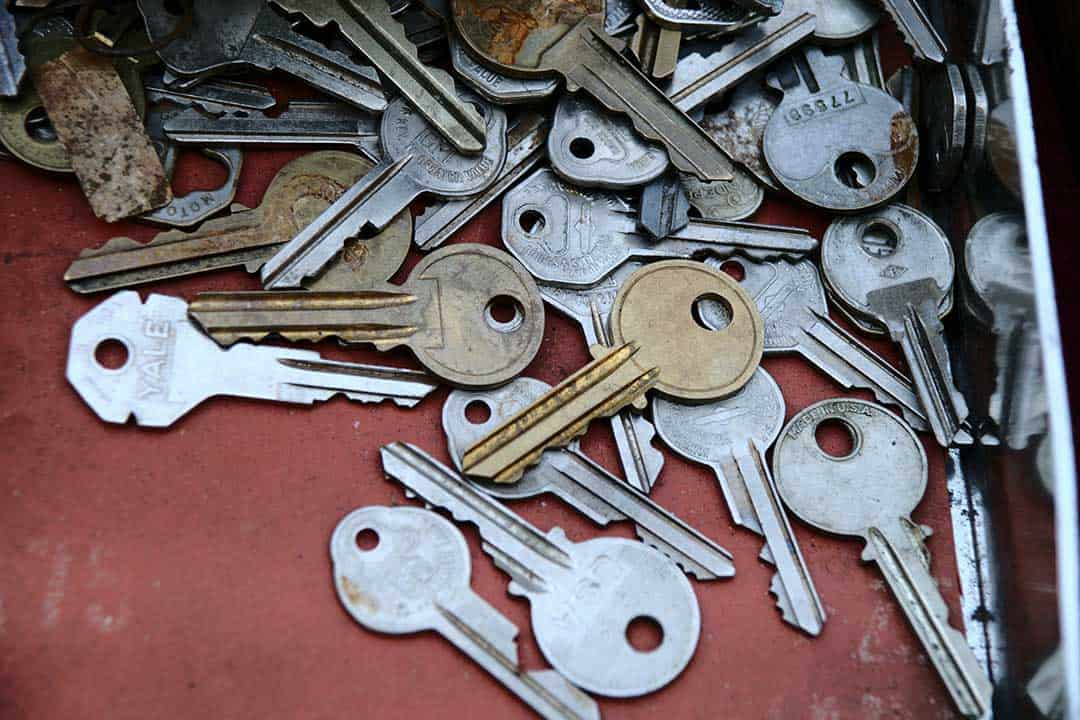 A large selection of keys in a pile on a red surface - Unlock Tax Free Dividends