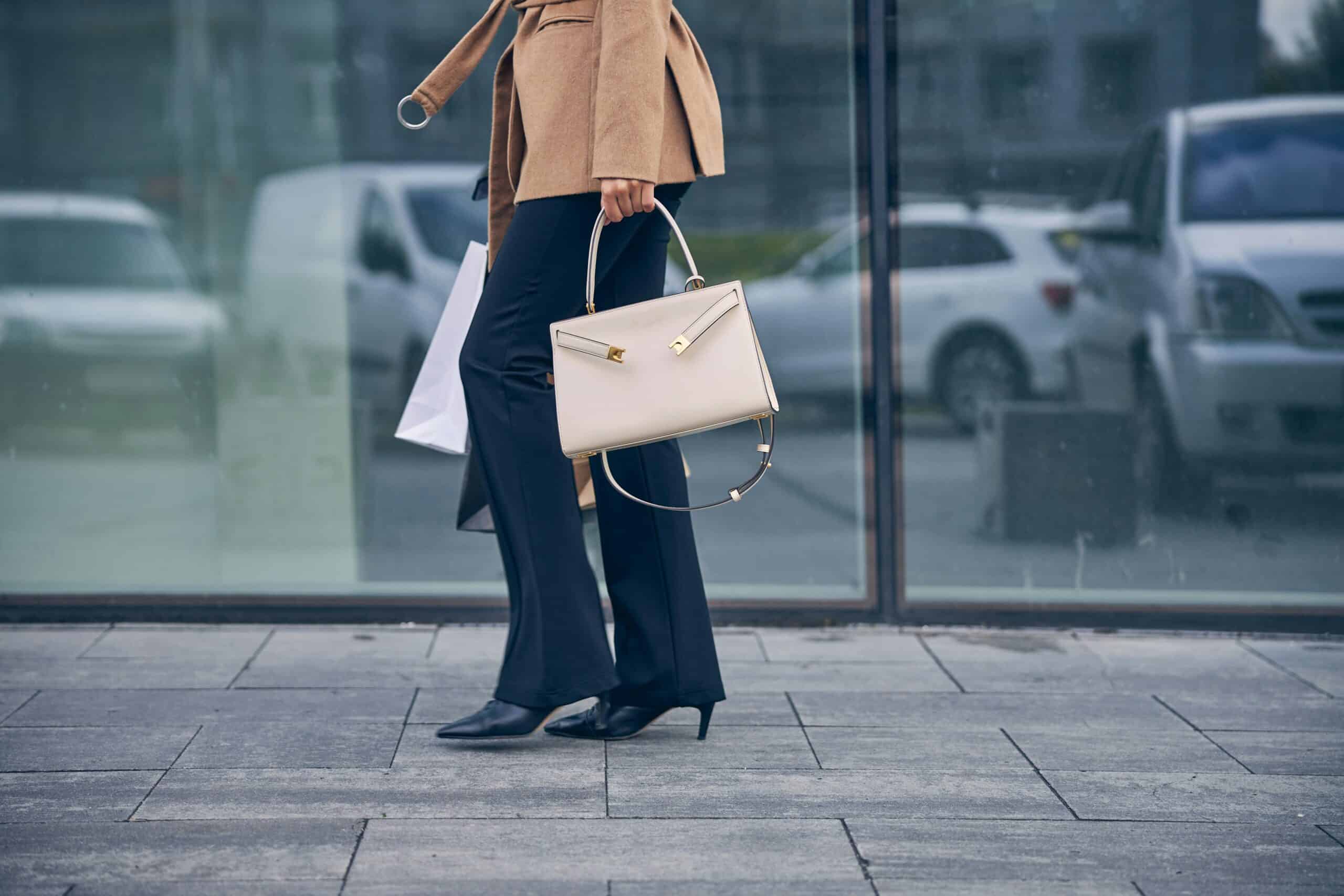 Woman walking to work carry a stylish handbag